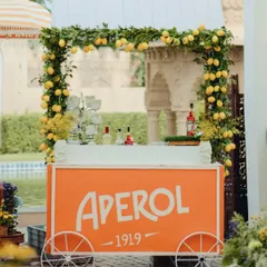 An Aperol cart, framed with a garland of fresh lemons, instantly sets a cheerful, Italian summer mood. It's these specific, sensory details that make a theme feel authentic and immersive.