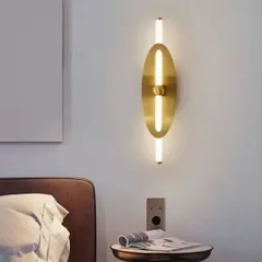 A sleek, minimalist wall sconce with a vertical light tube and an oval brass backplate. This fixture is perfect for adding a touch of modern elegance to a bedroom or hallway.