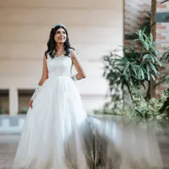 A full-length view of our bride's graceful look. The makeup is designed to look stunning from a distance, enhancing her features without being overpowering.
