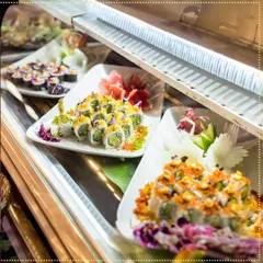 A glimpse into our live sushi bar display. We offer a wide variety of rolls, from classic California to inventive vegetarian options, all beautifully garnished and ready to be enjoyed.