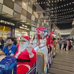 All aboard the fun express. Our Santa Claus entertainer and costumed performers take a ride on a toy train, delighting shoppers and adding a playful element to a mall's Christmas carnival.