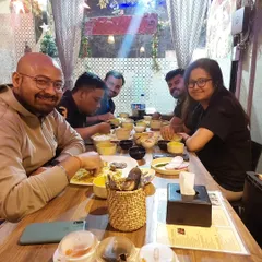 Smiles all around the table. This is what it's all about, bringing people together over good, authentic food.