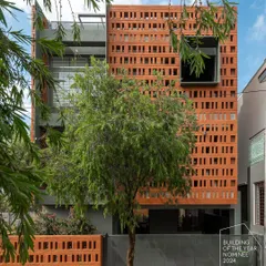 For the 'Big-Little House', we used a perforated brick screen to create a visually striking facade on a compact urban plot. This design provides privacy and ventilation while casting intricate light patterns, proving that even small footprints can have a grand architectural presence.