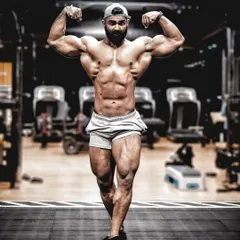 A powerful front double biceps pose, demonstrating the fullness of the chest and arms. Posing is a skill that requires practice, and I integrate it into my programs to help athletes present their physique with confidence.
