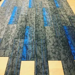 This shows carpet tile installation in progress for a commercial office space. These tiles are durable, easy to replace, and great for creating custom patterns in high traffic areas.