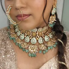 A detailed shot of the stunning mint-green kundan jewellery that we paired with her outfit.