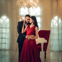 For a touch of fairytale romance, we can use elegant indoor sets. This shot of Nikhil and Anisha, surrounded by the warm glow of a chandelier, shows how a pre-wedding shoot can be both grand and deeply intimate.