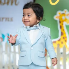 A charming close-up of the birthday boy in his light blue suit, looking dapper and ready to celebrate his first birthday.