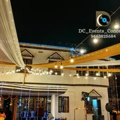 Another angle of our house lighting service, showing how we use drapes and lights to create a festive canopy over the seating area.
