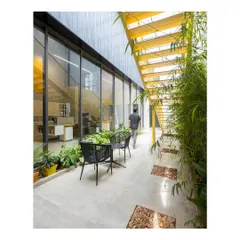 I designed this internal courtyard to bring nature into the workplace. It serves as a tranquil breakout space and provides a green view for the adjoining offices, promoting employee well-being.