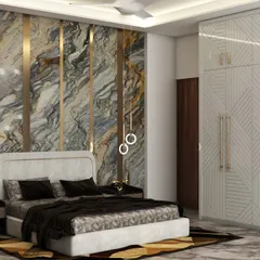 This master bedroom showcases our use of bold, luxurious materials. A floor-to-ceiling marble accent wall with integrated brass strips creates a dramatic backdrop for the custom upholstered bed, complemented by modern ring pendant lights.