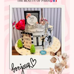 A chic and elegant cake inspired by the beauty of Paris, designed for a "50 and Fabulous" celebration. The cake features hand-painted illustrations of Chanel storefronts and the Eiffel Tower.