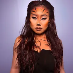 A full view of the powerful tiger-inspired creative makeup look. This demonstrates the fusion of imagination and technique that we nurture in our advanced artistry modules.