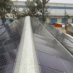A close-up of the rooftop panel installation at the Bangalore hotel. The sleek, angular design is tailored to the building's structure, maximizing energy generation without compromising aesthetics.