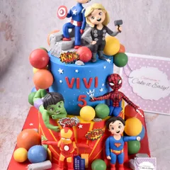 Avengers assemble! This action-packed two-tier cake features a whole team of superheroes, including Captain America, Thor, Superman, Spider-Man, Hulk, and Iron Man. Everything from the figurines to the chocolate balls and city debris is handmade.