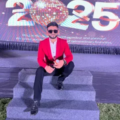 Mic in hand, ready to kick off the New Year's Eve 2025 festivities. This shot captures me in my element, sitting on the stage steps and connecting with the crowd before the main event begins.
