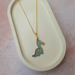A rawr-some dino charm necklace for the little adventurer. The blue dinosaur pendant with floral details is both cute and cool.