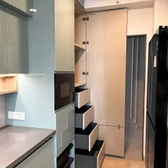 A tall pantry unit with internal drawers provides exceptional storage capacity. This design allows you to see and access all your pantry items easily, combining the sleek look of a full-length cabinet with the practicality of pull-out drawers.