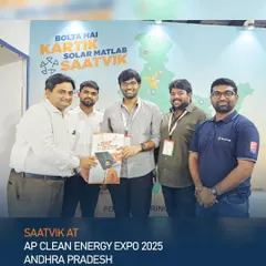 Our team celebrating a successful interaction at the AP Clean Energy Expo, with our "Bolta Hai Kartik" campaign in the background.