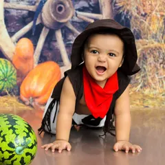 Howdy, partner. This little cowboy is ready for a wild west adventure, crawling through our rustic barn-themed set.