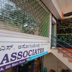 This living vertical garden adds a beautiful natural element to the entrance of a commercial business. The green wall is a refreshing sight next to the building's sign and entryway.