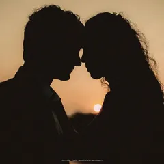As the sun dips below the horizon, it paints the perfect silhouette of two people completely lost in their own world. This shot is all about the quiet connection, the unspoken promises, and the simple beauty of being together against a dramatic natural canvas.