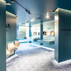 In the Vitra showroom, I used a monolithic color scheme and strategic lighting to create an immersive brand experience. This view highlights how floating displays and uncluttered pathways guide customers through the space.
