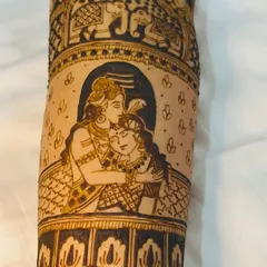 A close-up of a Shiva and Parvati portrait on the forearm, capturing a tender moment. This is a popular and meaningful element for bridal designs.