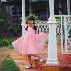 Twirling in her pretty peach dress! This outdoor shot for a FirstCry collaboration highlights the beautiful movement and detail of the dress.