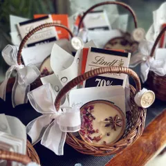 These are not just gifts, but curated moments. These mini baskets, filled with Lindt chocolate and a scented candle, make for perfect wedding favors or corporate gifts. Each one is finished with a delicate ribbon and a wax seal.