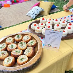 A beautiful spread of classic cheese sandwiches and exotic veggie buns, perfectly arranged for a themed birthday brunch.