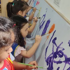 A close-up view of our young artists deeply engaged in their work. I provide the tools and the space, and they bring their unique creativity to the canvas, making their own artistic choices.