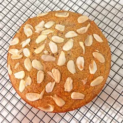 A top-down view of the gluten-free French Almond Cake, showcasing the beautiful texture and the generous topping of toasted almonds. It’s as delicious as it is beautiful.