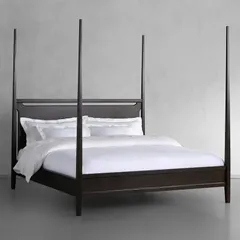 Our Brooklyn Bed, a modern take on the classic four-poster. Handcrafted by Indian artisans from solid ash wood, this bed is stained and sealed by hand to achieve a rich ebony color, with a clear lacquer topcoat for protection and a subtle sheen.