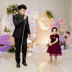 I love making the birthday child the star of the show. Here, I'm sharing a magical moment with a young volunteer during her party. My goal is to make their special day even more memorable.