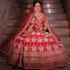 A full-length view of a stunning bride in her traditional red wedding lehenga. My goal is to create a cohesive look where the makeup, hair, and outfit all come together in perfect harmony.