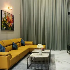 A bold statement in a modern living room. This custom L-shaped sofa in vibrant yellow is paired with industrial-style nested coffee tables and floor-to-ceiling curtains, showcasing my ability to work with dynamic color palettes.