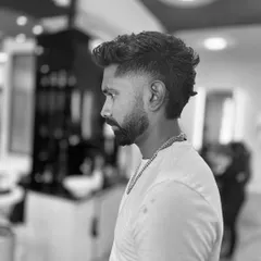A modern mullet is all about the contrast between the short sides and the longer back. This black and white shot highlights the shape and texture of this bold haircut.
