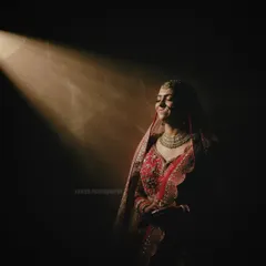 The bride turns towards the light with a gentle smile, her face illuminated beautifully. This portrait is both artistic and emotional, a signature style of my wedding photography.