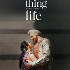 A powerful, high-contrast shot of the couple, their embrace highlighted against a dark background, with the quote 'the best thing to hold onto in life is each other.'