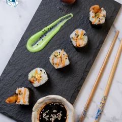 I believe in food as art. This plate of sushi is meticulously crafted and plated with wasabi aioli and pickled ginger, showcasing the precision and care I put into every dish. It's an ideal choice for impressing clients at an executive event.