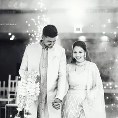 The same magical reception entrance, presented in a classic black and white edit. This timeless style emphasizes the pure joy and emotion on the couple's faces as they walk hand in hand.