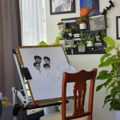 My studio setup for the large A1 size family portrait. You can see the initial faces taking shape on my drawing board, with the reference photos close by for constant comparison.