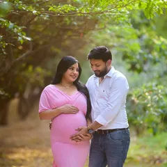 A candid moment between the couple as they walk through a lush green pathway. I focus on capturing these simple interactions that show the love and anticipation of this special journey.