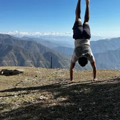 A handstand with a view. The Himalayas in the background make for a pretty epic place to practice balance and strength.