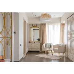 The cozy seating nook features two plush armchairs, a delicate coffee table, and a beautiful vanity. It’s the perfect corner for a morning coffee or quiet reading.