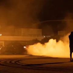 A silhouette of me in my element, standing in the thick of tire smoke during a night drift shoot. Capturing these moments requires being right in the action.