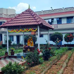 The peaceful garden of an ashram in India. Creating an ashram, or sacred space, within your own life is essential. It can be a place for silence or chanting, free from distraction, where you can focus on your divine connection.