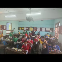 A classroom full of happy students at Our Lady of Salvation High School, holding up the clay crafts they made during my Fevicryl workshop.
