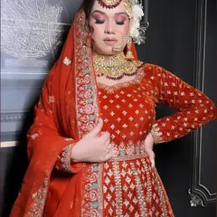 Another angle of the red-orange velvet bridal anarkali, showing how the rich fabric drapes. The full sleeves are finished with detailed embroidery at the cuff, ensuring every part of the outfit feels special.